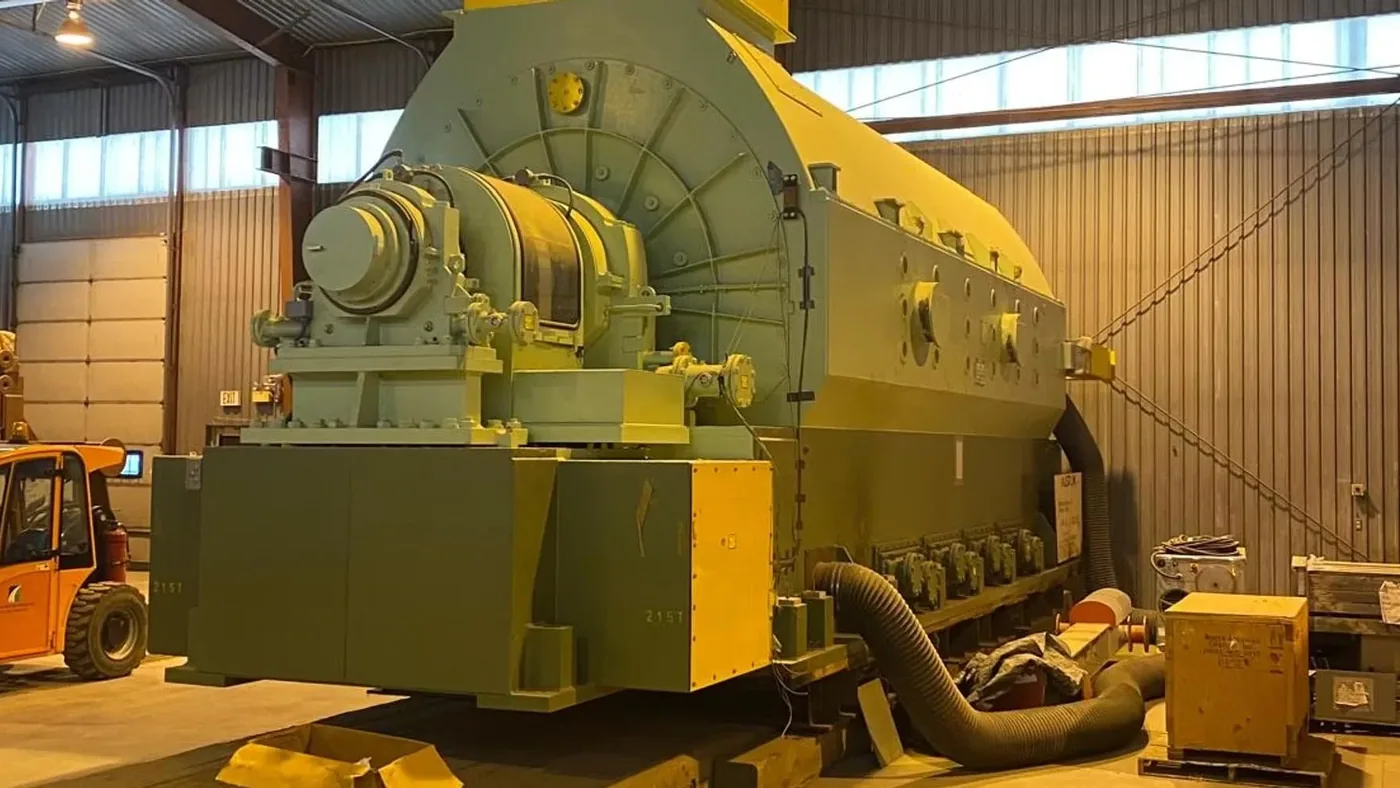The Alstom 160 MW steam turbine generator set in covered storage, generator end